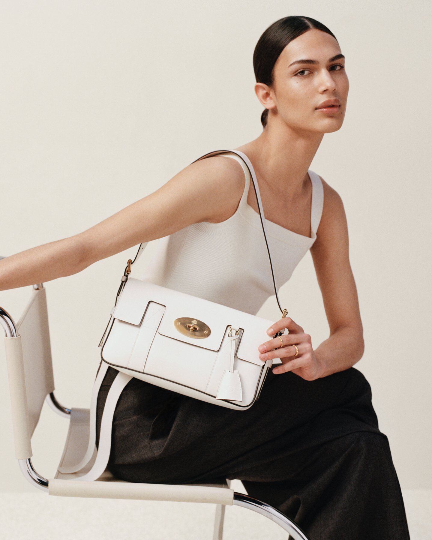 model wearing mulberry east west bayswater bag in white